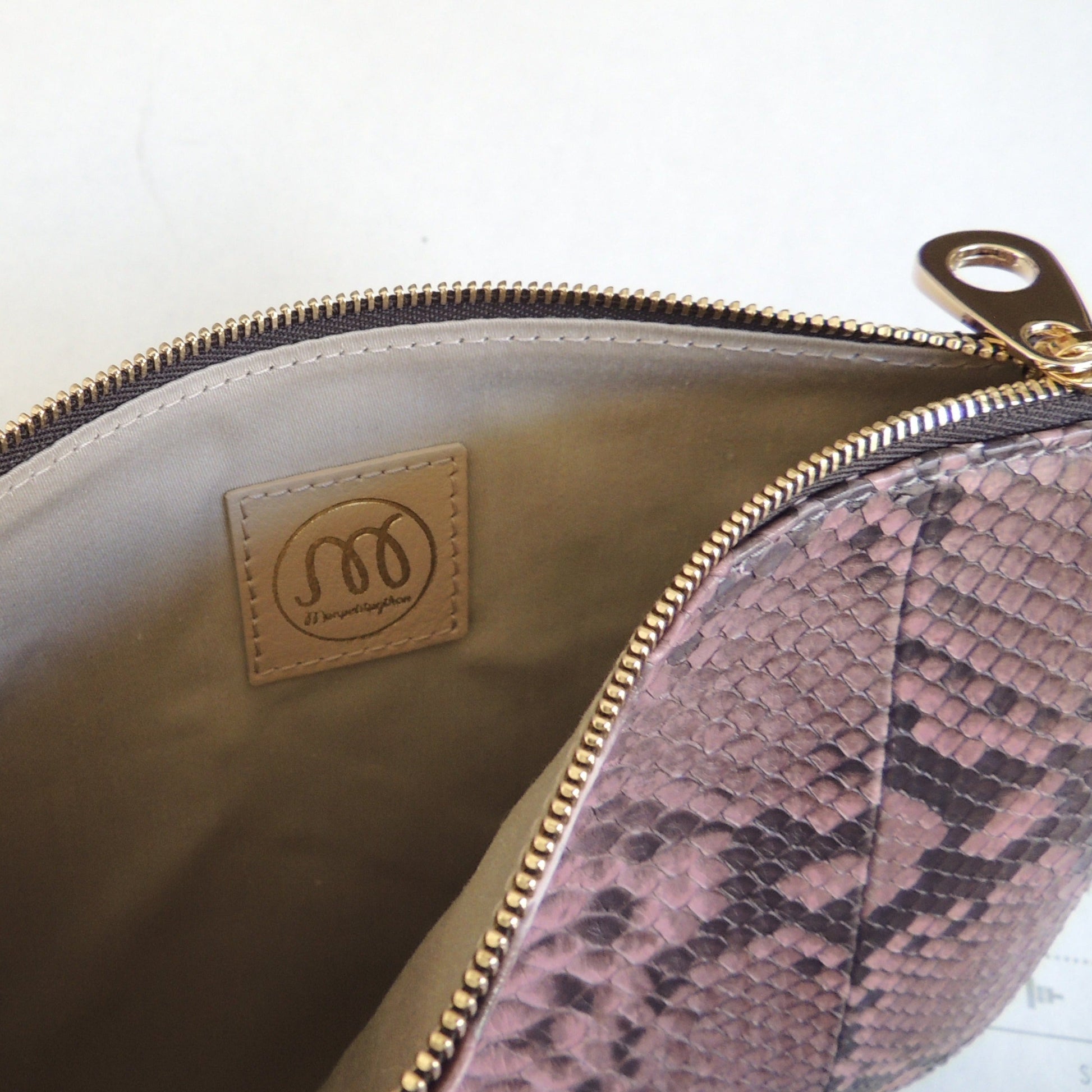 Detalle interior de cartera de mano en piel de serpiente pitón natural